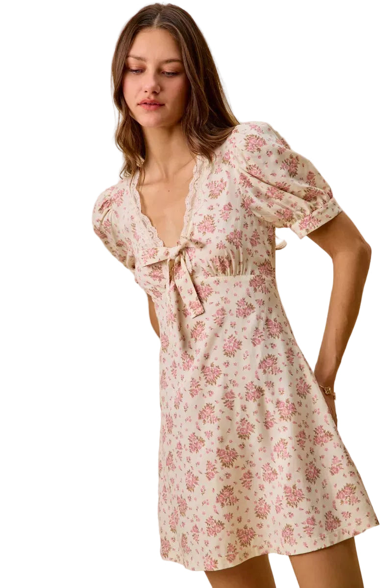 Cream floral mini dress with lace edge V-neck and tied bow at bust