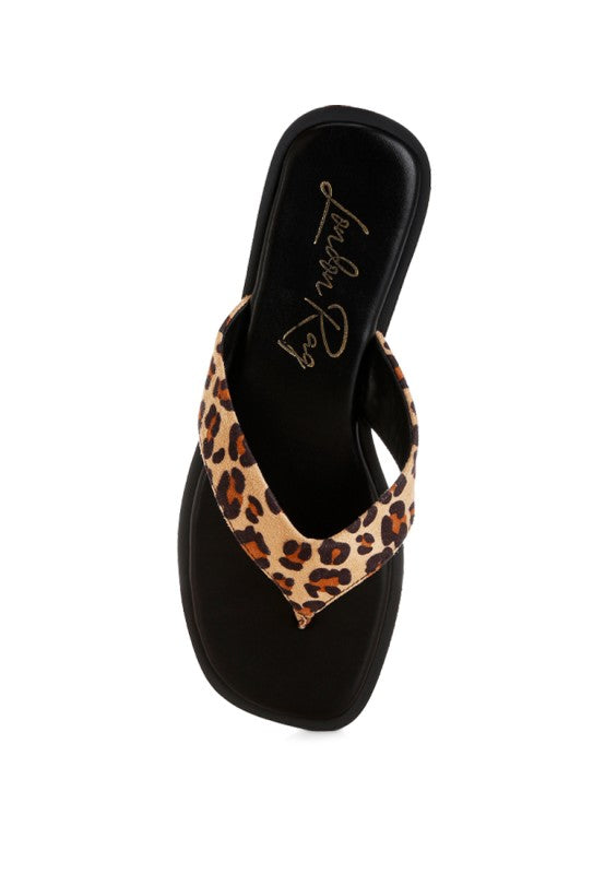 Black interior thong flat sandal with leopard print strap and embossed lining