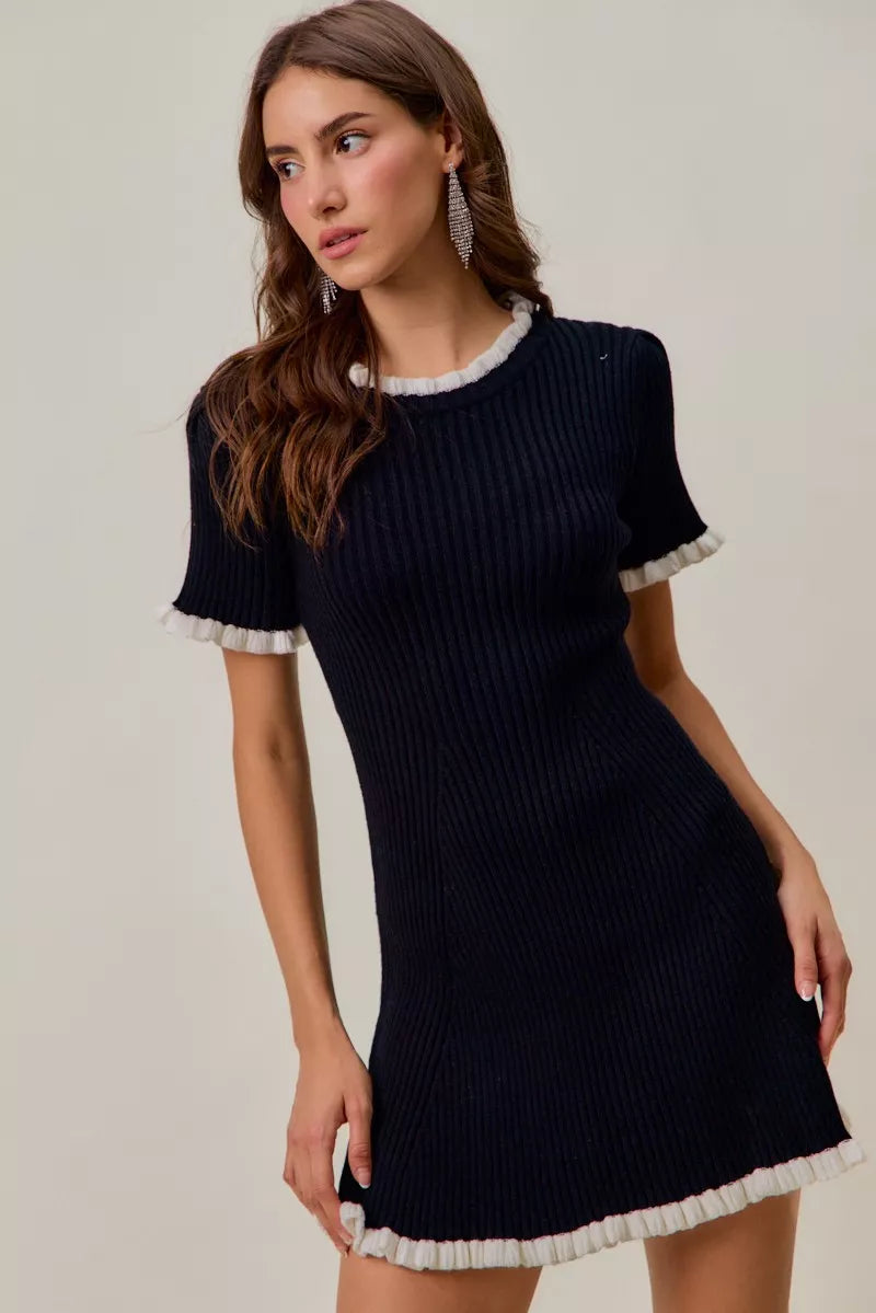 Contrast ruffled knit mini dress, black with white trim at neckline, sleeves, and hem