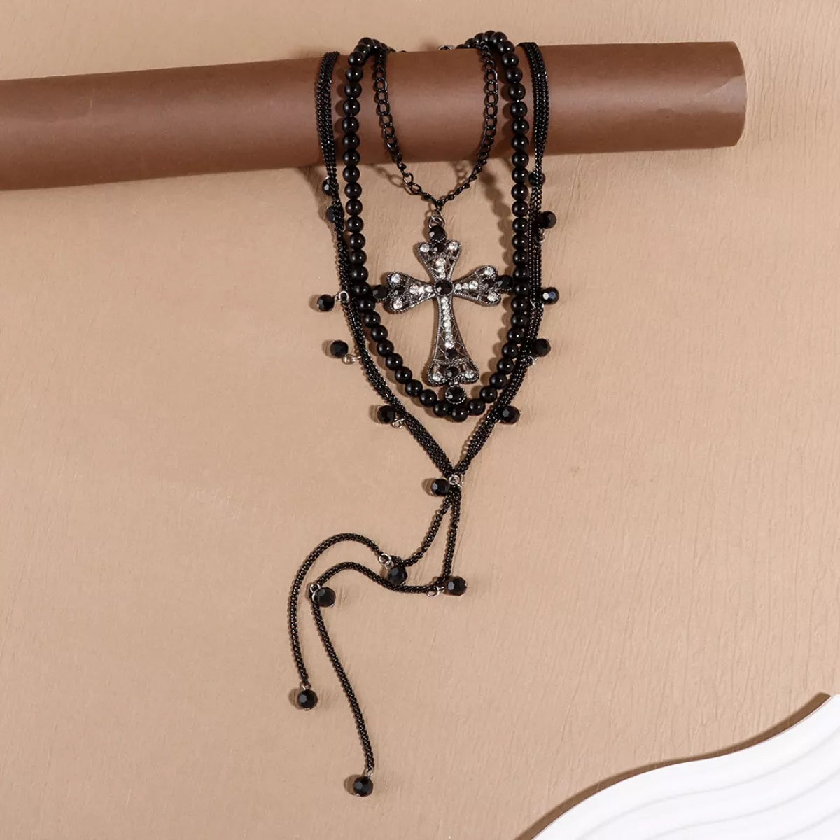 Black pearl cross pendant necklace set with jeweled cross charm and long beaded tassel