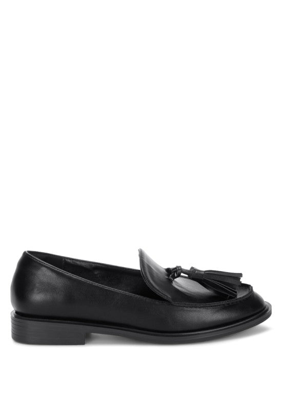 Black tassel loafer profile with low stacked block heel and closed round toe