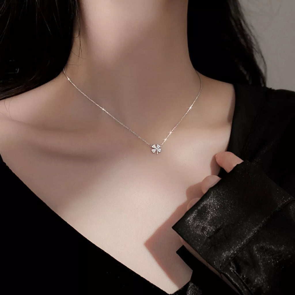 Sterling silver four-leaf clover zircon necklace worn at the neckline