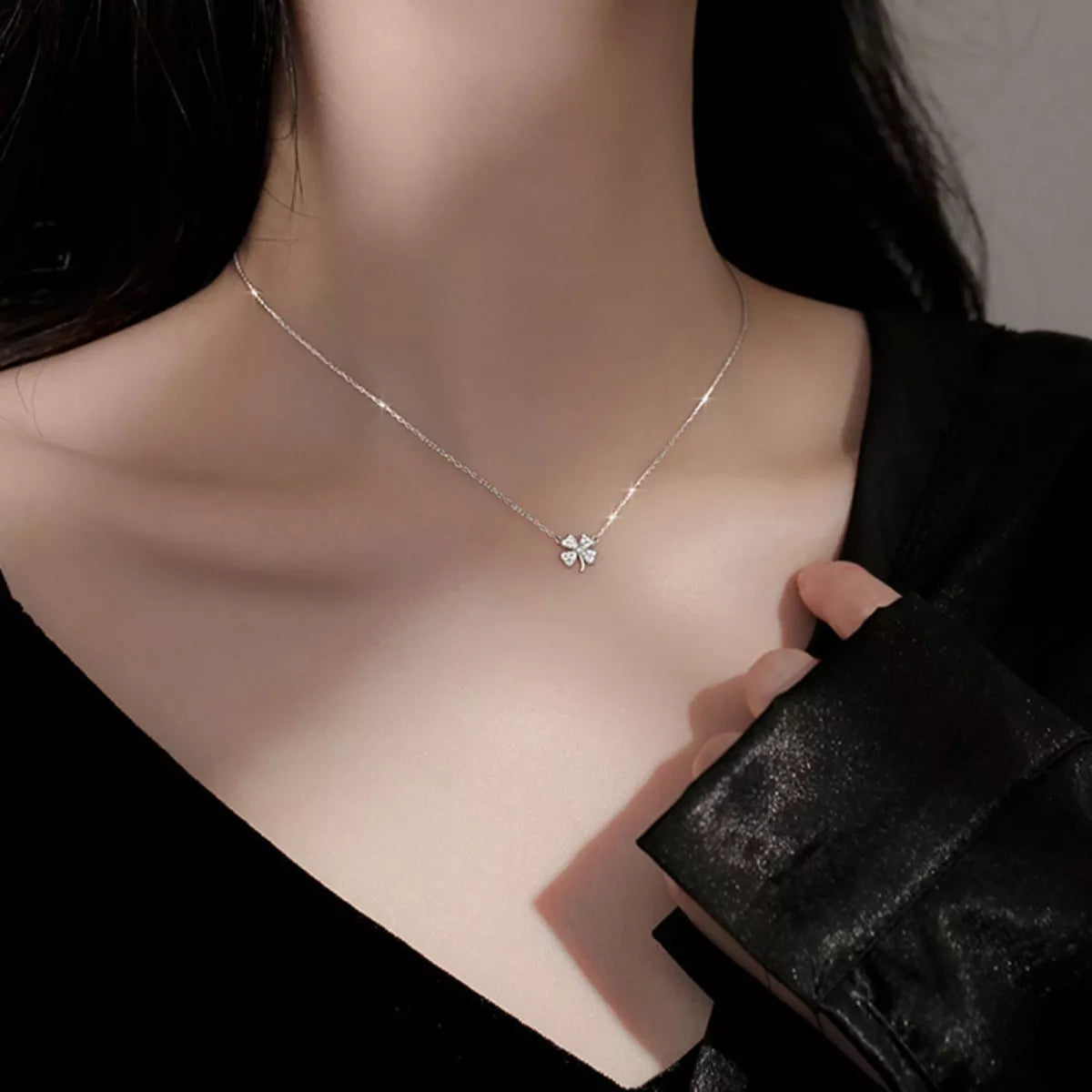 Sterling silver four-leaf clover zircon necklace worn at the neckline