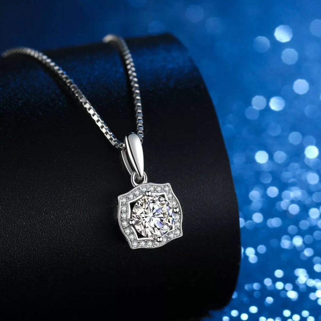 Silver chain necklace with round moissanite-style center stone in hexagon halo setting