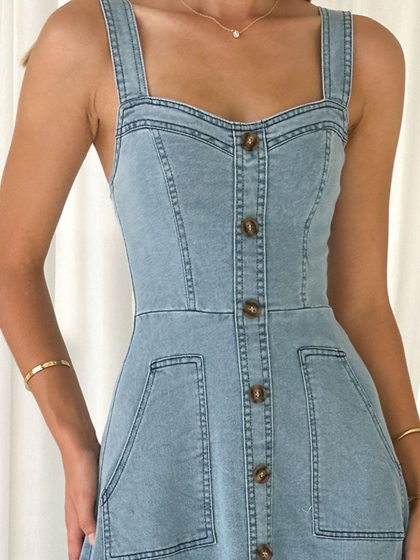 Light blue denim button-front bodice with patch pockets and visible button placket