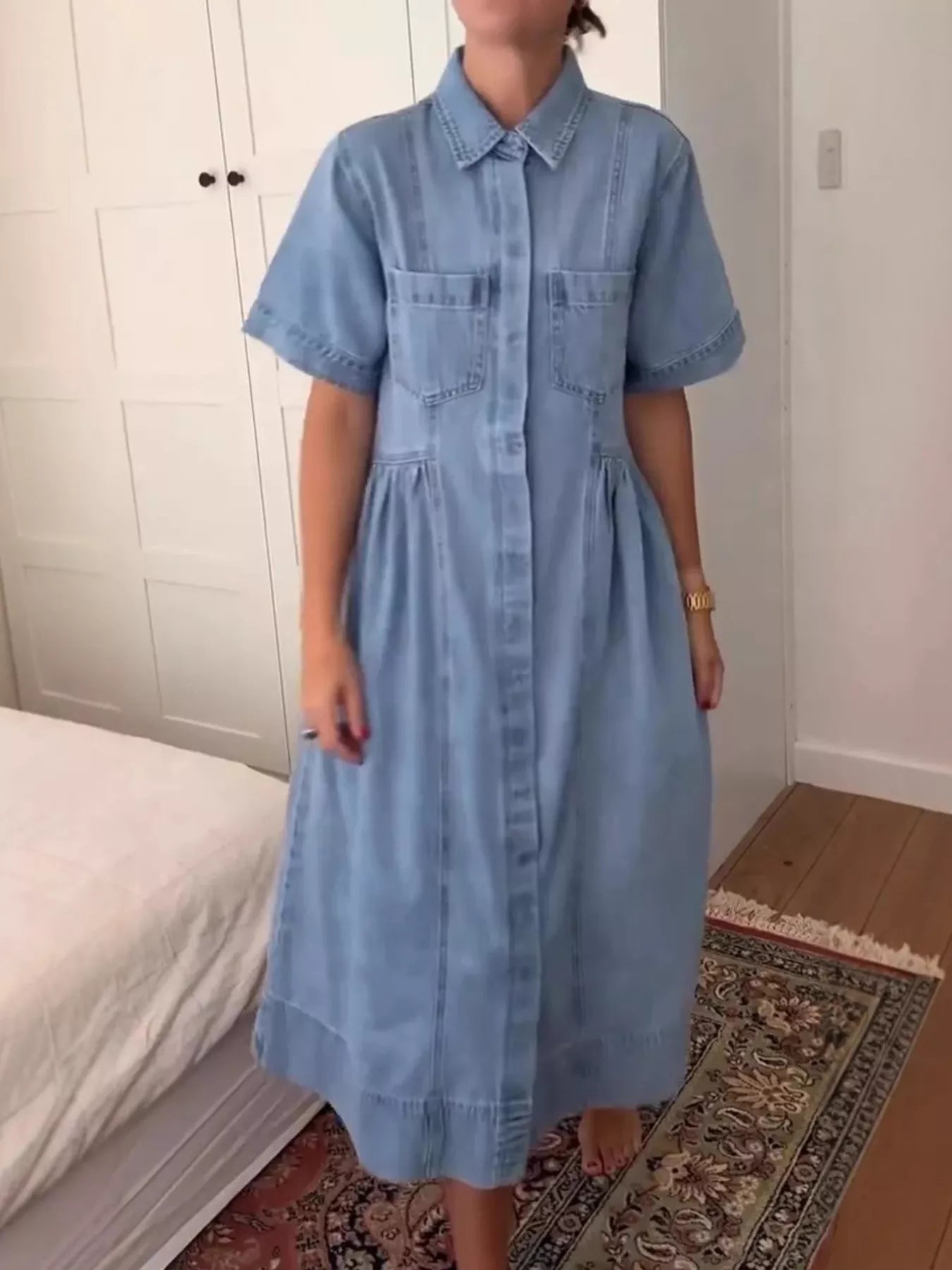 Blue denim midi dress: collared neckline, button front, and two chest pockets