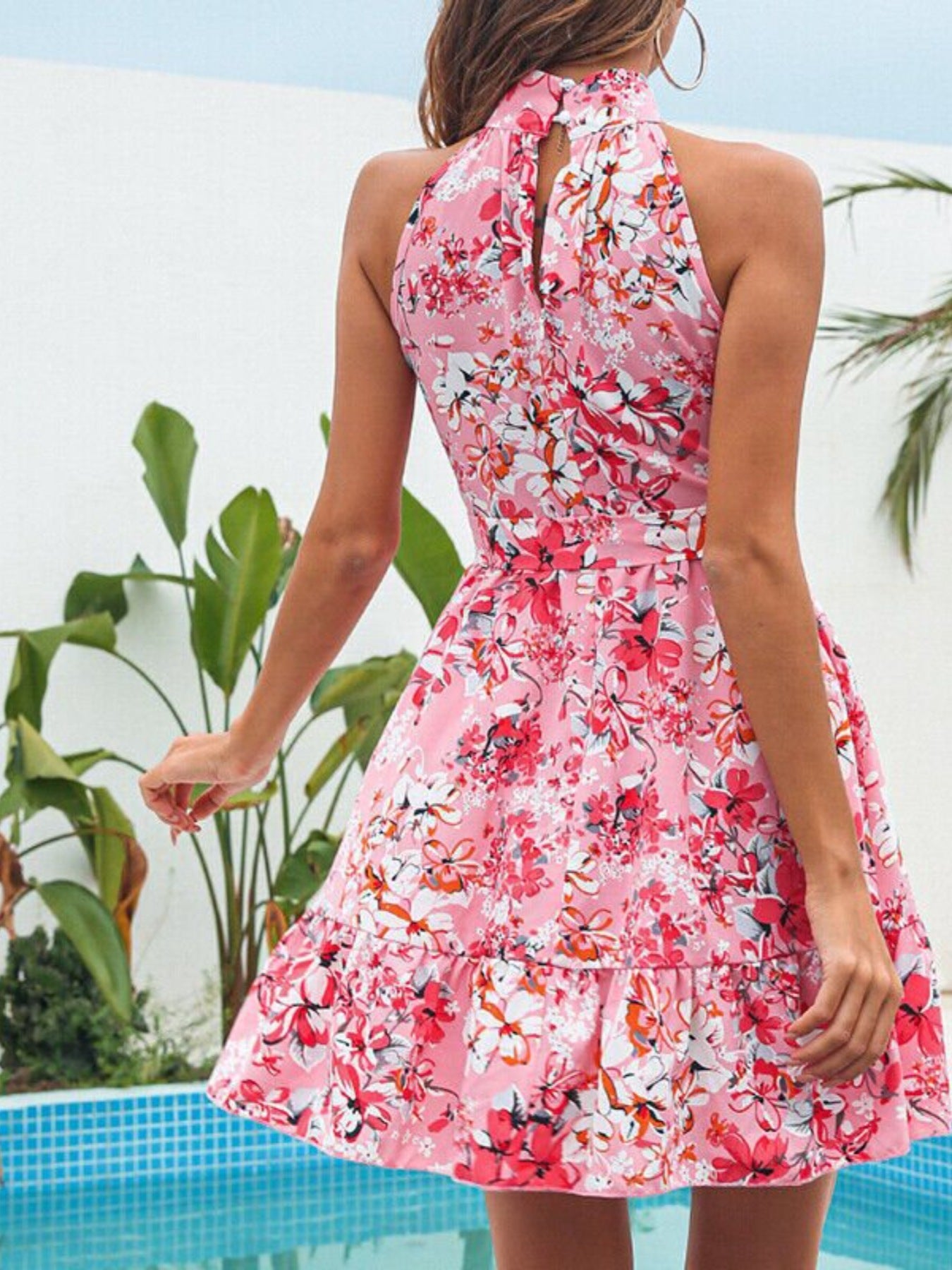 Pink floral halter mini dress, bow tie at waist, open back detail