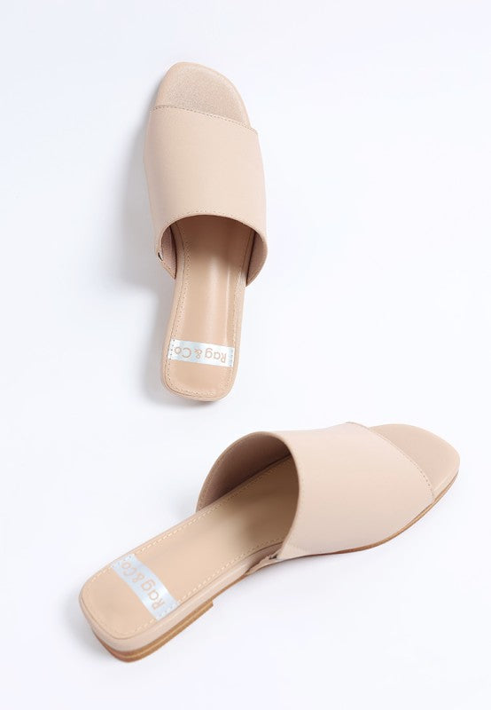 Beige mule flats, side view, open square toe, smooth leather upper, flat sole