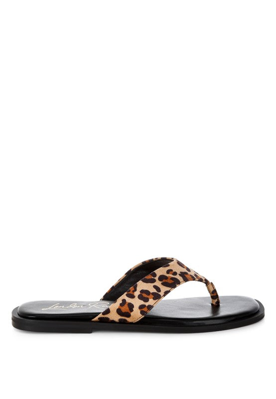 Leopard print slide sandal with thong toe and black contoured footbed