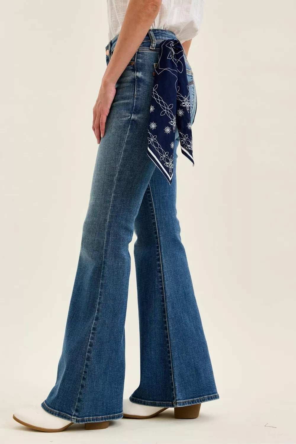 Mid-rise flare jeans in medium wash; back view with yoke seams and bandana loop