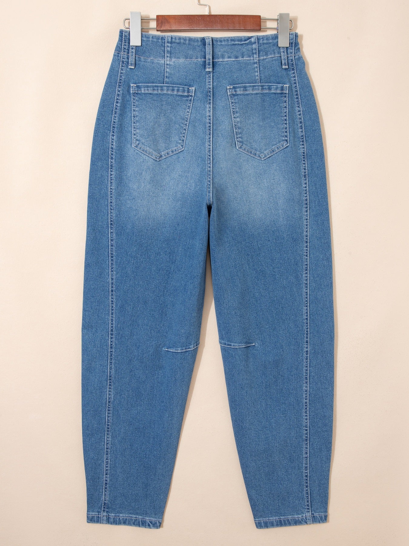 Medium-wash barrel jeans with back yoke seam, patch pockets, and belt loops