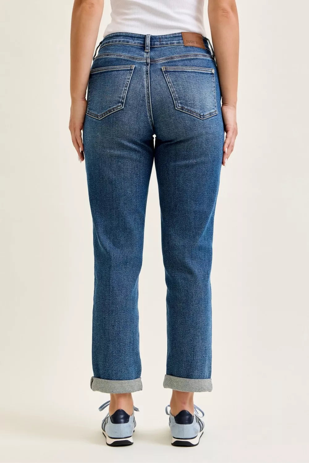 Medium blue mid-rise boyfriend jeans, button fly and back patch pockets