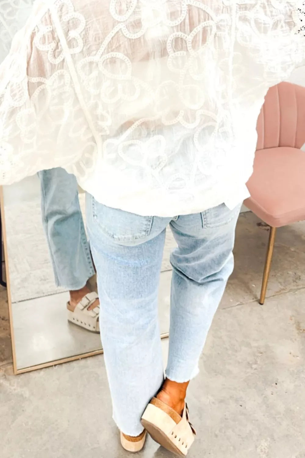 Light wash straight-leg jeans with cuffed look and frayed hem edge