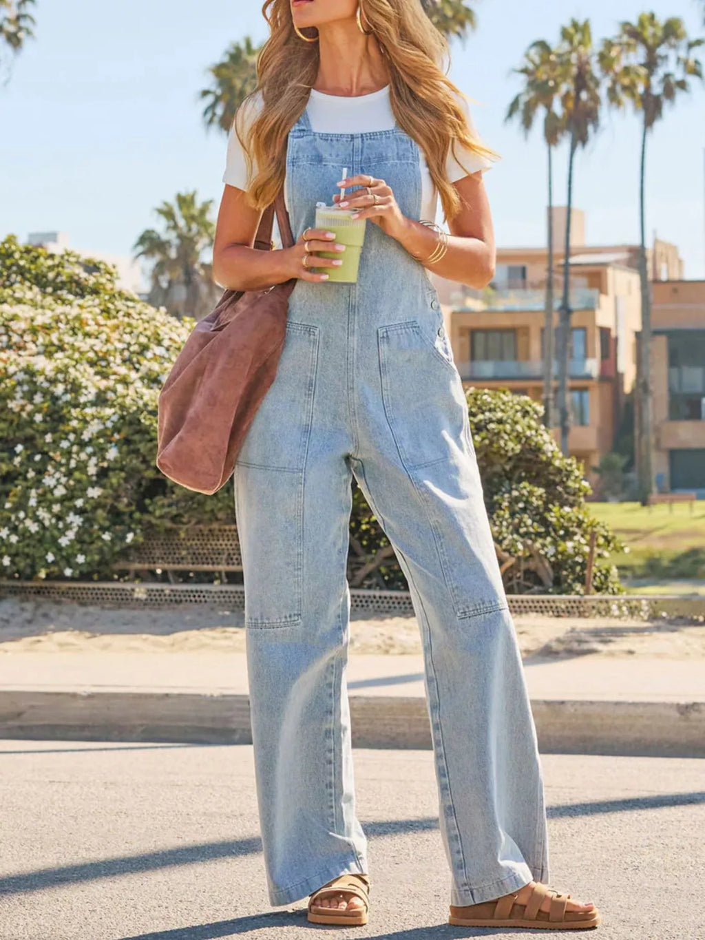 Light blue wash denim wide-leg overalls with bib pocket and loose, straight leg fit