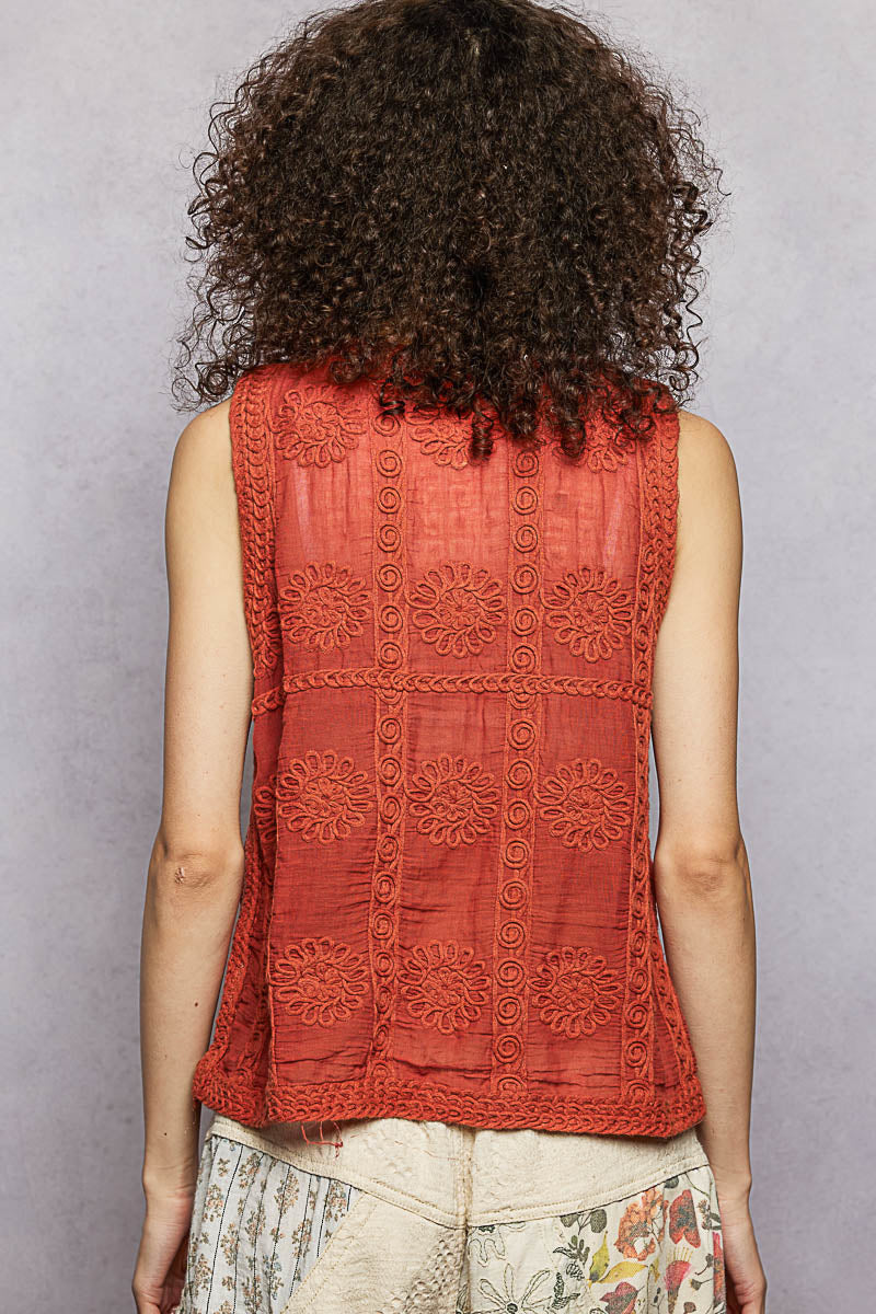 Back view of ginger sweater vest with V-neckline and decorative knit texture