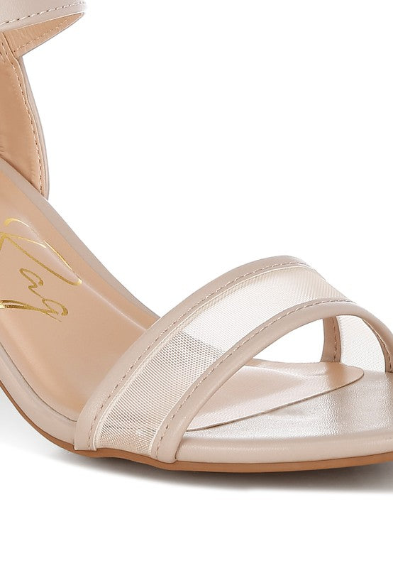 Beige heeled sandal close-up of mesh strap and smooth ankle strap with stitching