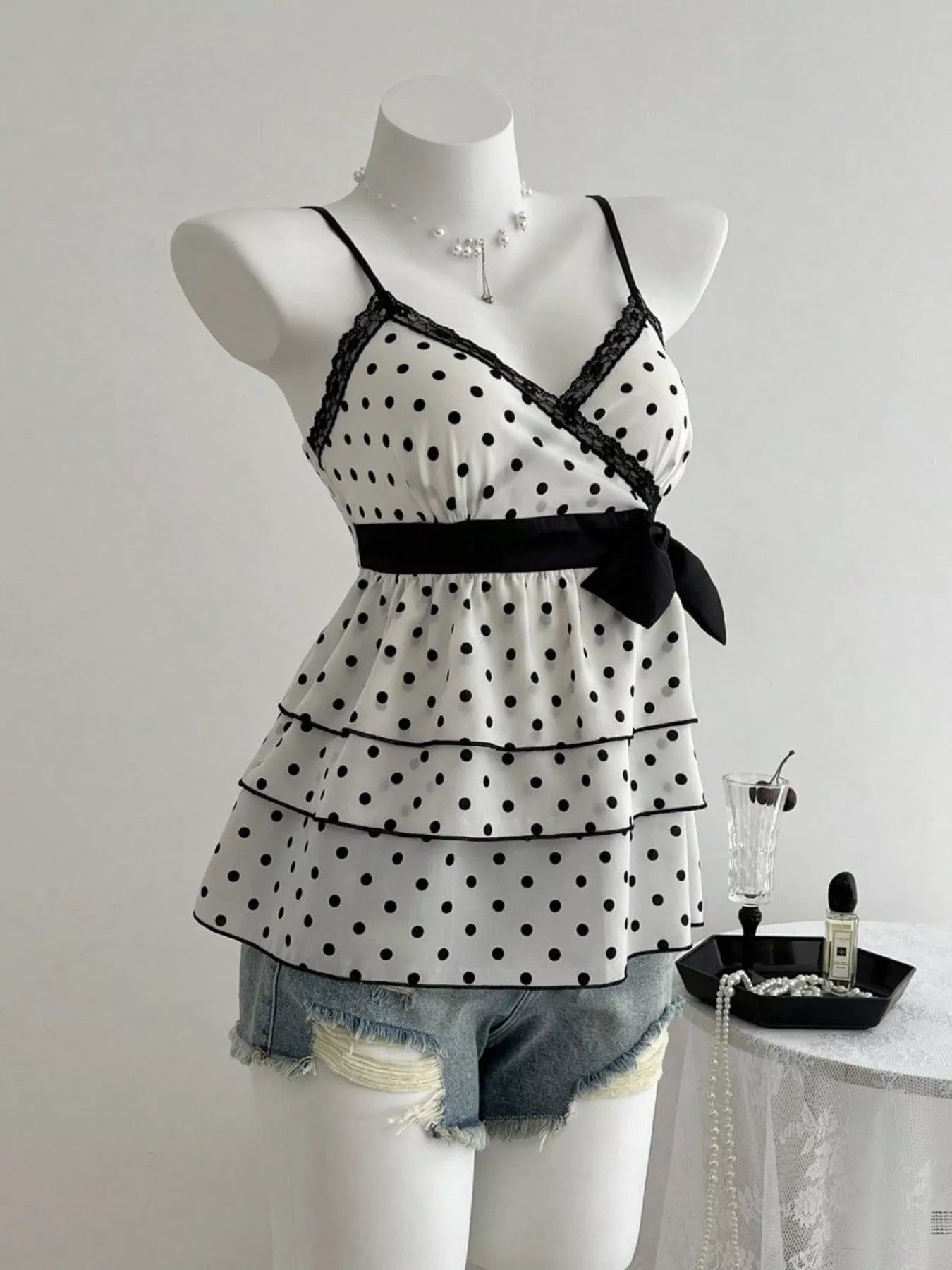 Trendsi black polka dot ruffle-hem cami with lace neckline and waist bow