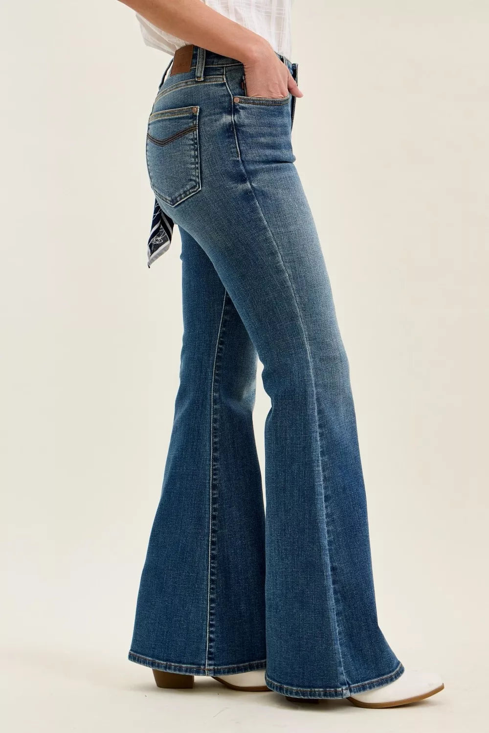 Trendsi mid-rise flare jeans in medium wash; side view of the wide bell leg