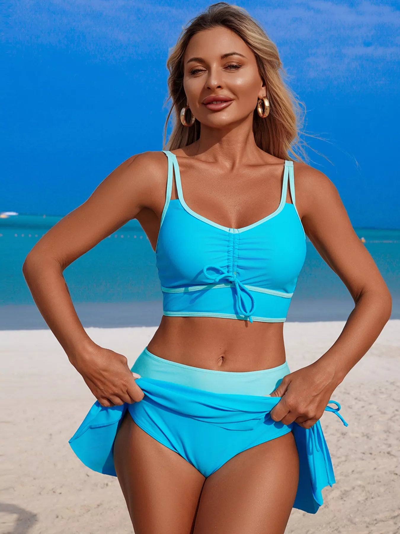 Sky blue two-piece swim set: tie-front bikini top and ruffle hem skirt
