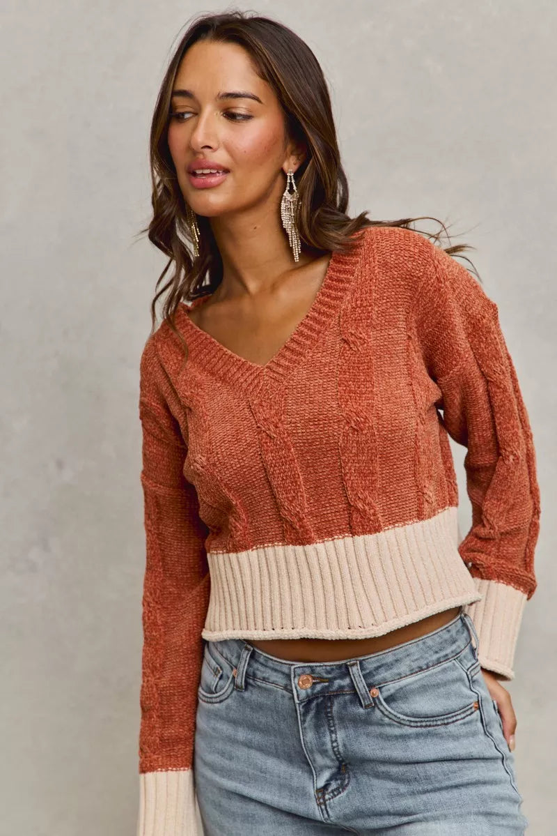 Rust chenille V-neck cropped sweater with cable-knit pattern and contrast cuffs