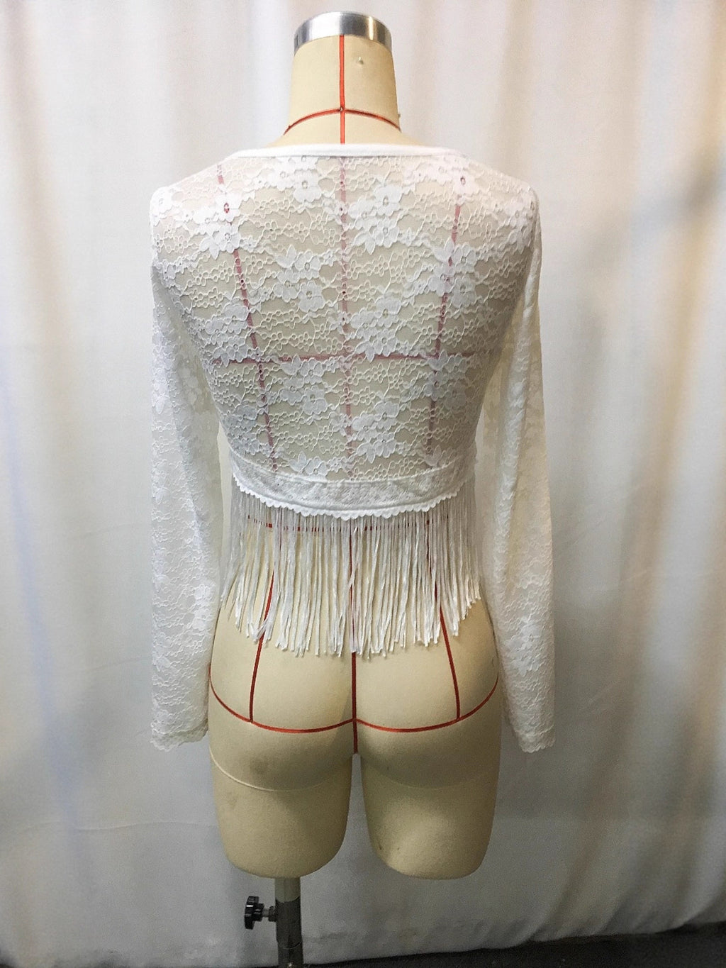 White lace long-sleeve top, back view, with scalloped yoke and fringe hem