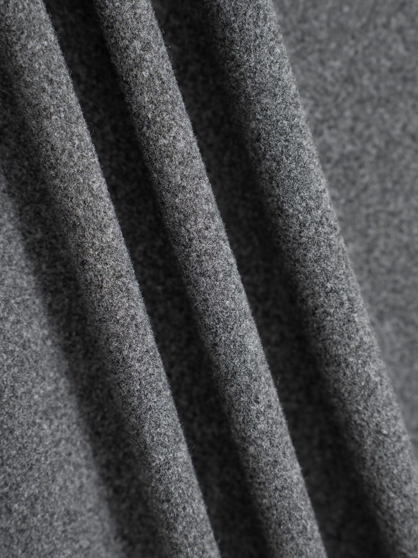Gray knit fabric texture of relaxed drawstring pants, close-up