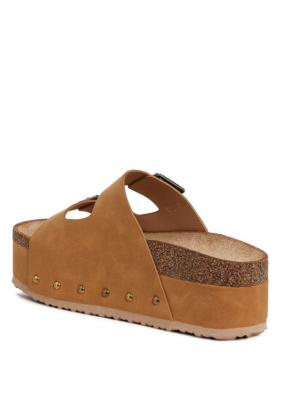 Tan flatform slide sandals, side view with buckle strap and stud row