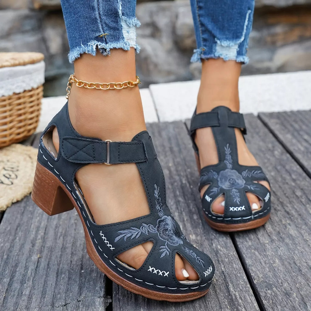 Black cutout block heel sandals with wide ankle strap and floral embroidery
