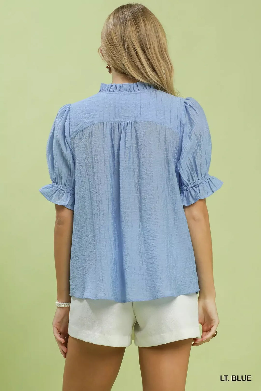 Light blue textured blouse with puff sleeves and back yoke pleats