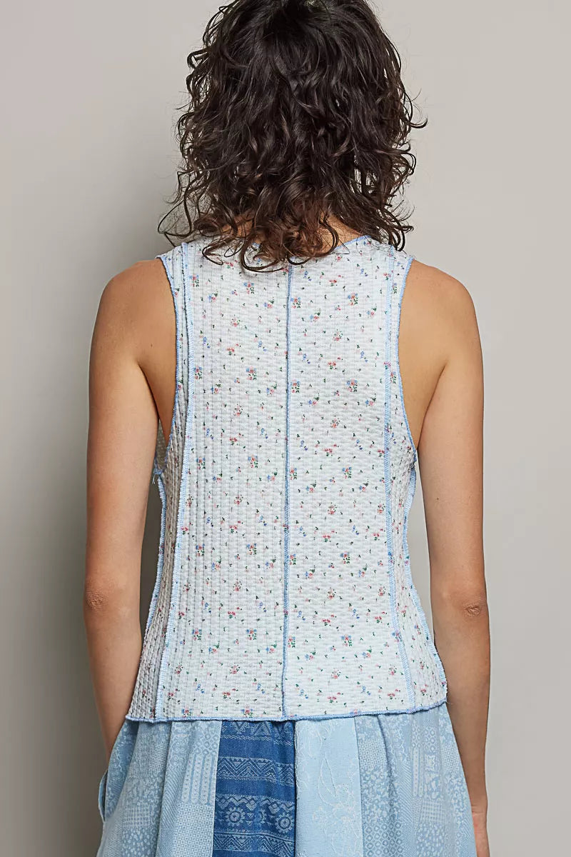 Back view: light blue ribbed tank; vertical seam detail, micro-floral print