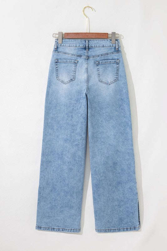 Light blue jeans on hanger, relaxed wide leg with front pockets and belt loops.