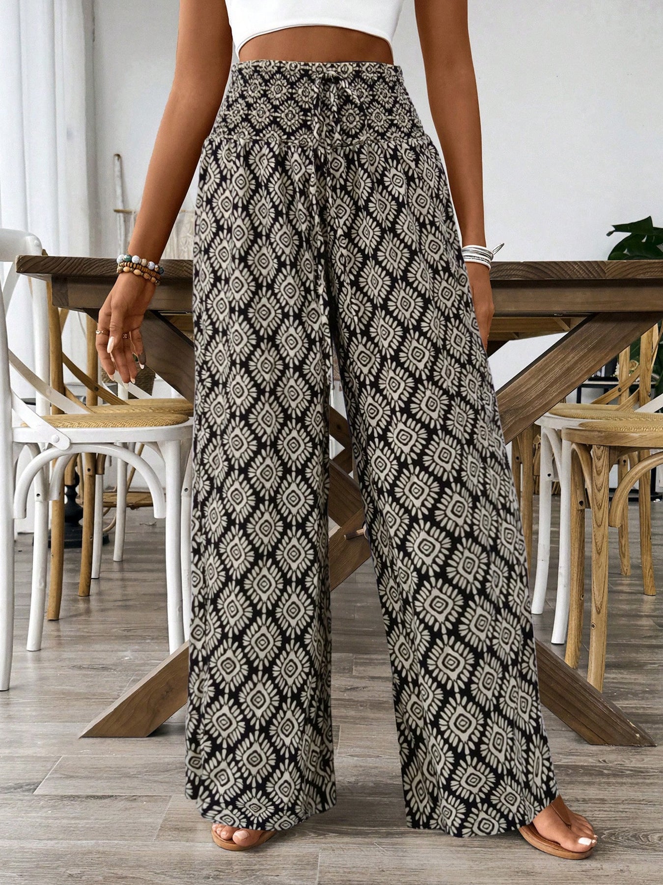 Black printed wide-leg pants with diamond pattern and elastic waistband