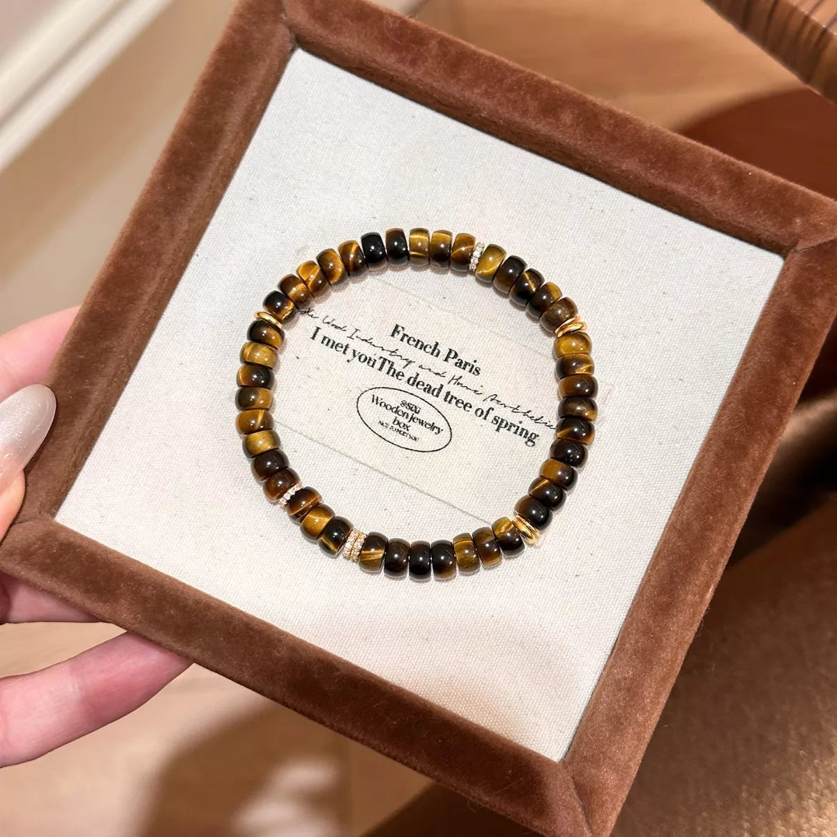 Tiger's Eye beaded bracelet with brown and black striped round beads on card