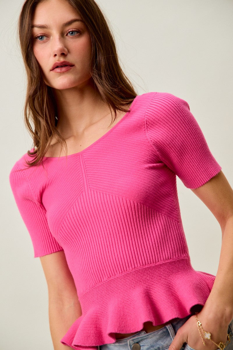 Hot pink ribbed knit peplum sweater top with seam detailing and short sleeves