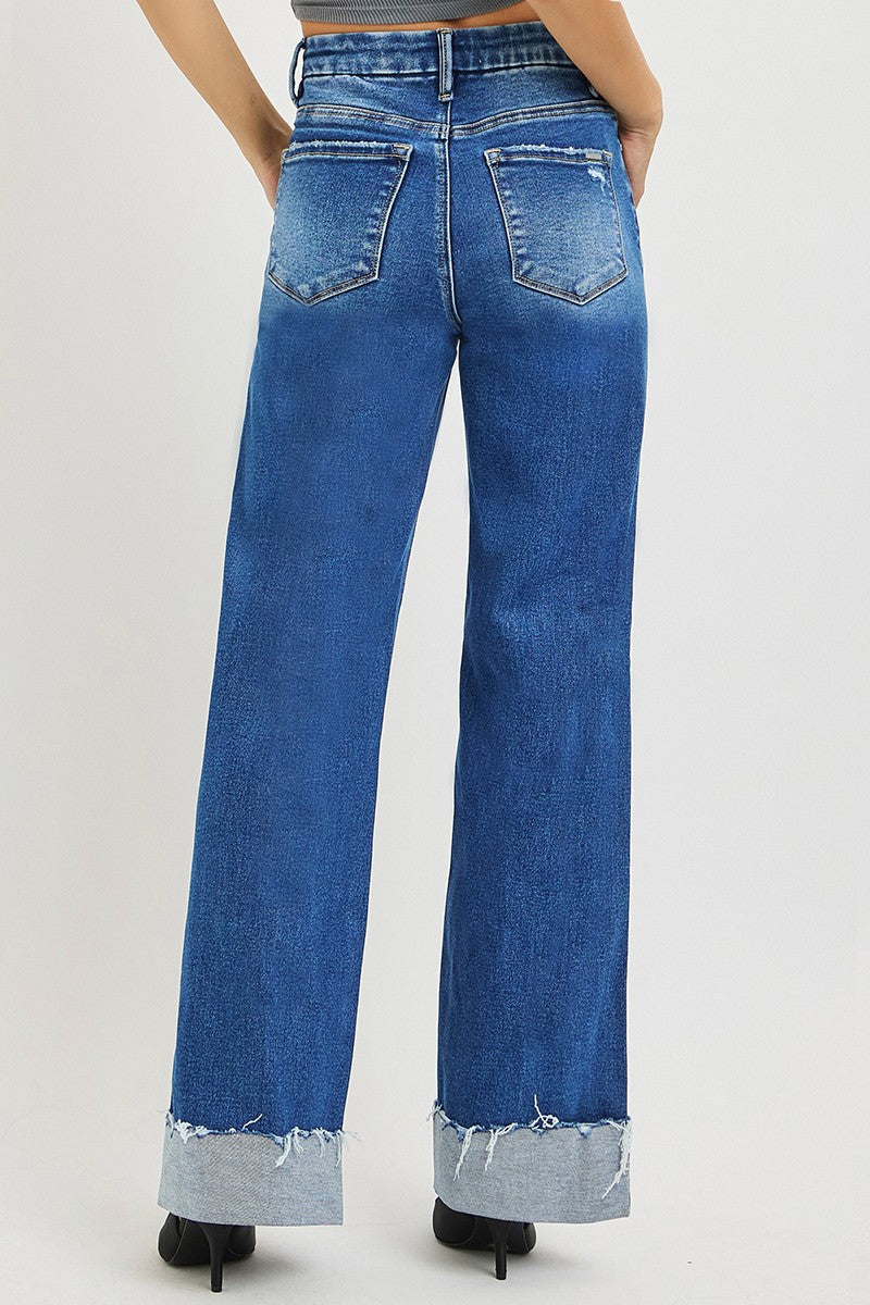 Medium wash blue wide-leg jeans with button fly, front pockets, and cuffed hem