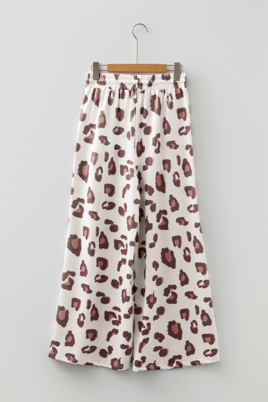 White leopard-print pants with elastic waist and drawstring, wide leg silhouette