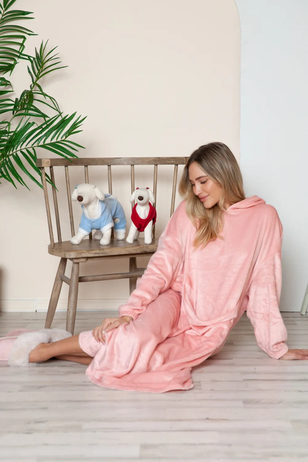 Dusty pink hooded midi lounge dress, seated side view with front pocket