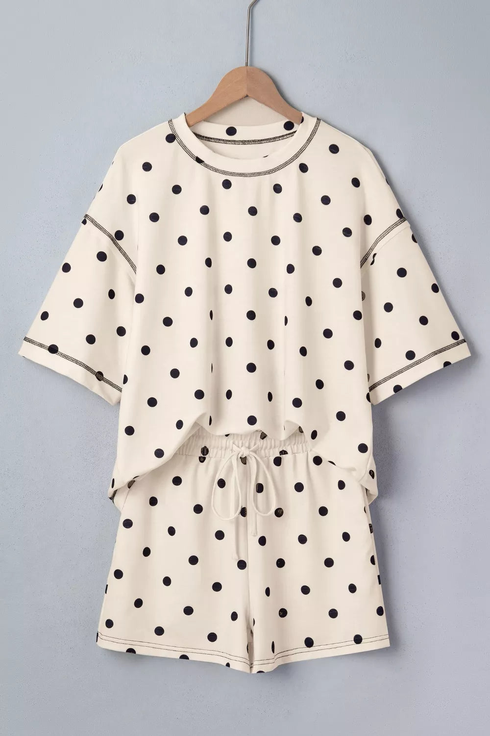 Cream polka dot loose tee and shorts set on hanger; elastic waist and tie drawstring