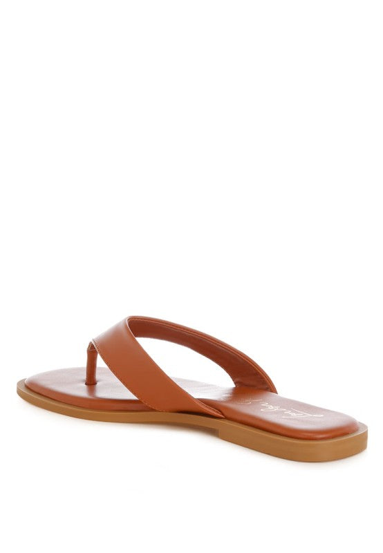 Brown-orange toe-post thong flats with wide thong strap and flat sole