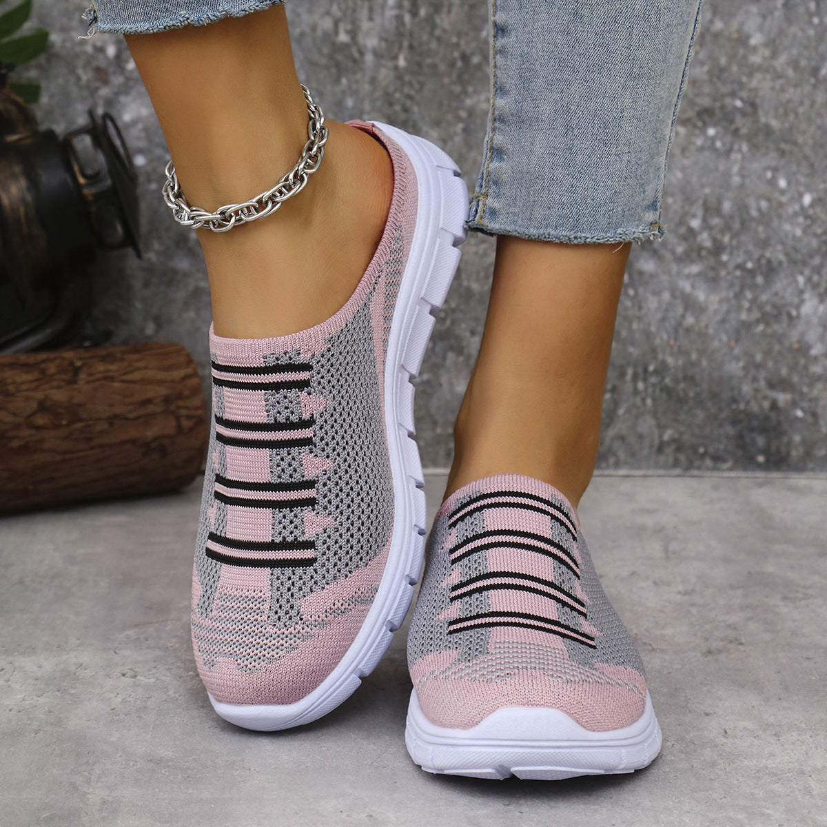Pink knit slip-on sneakers with black striped knit graphic and white chunky sole