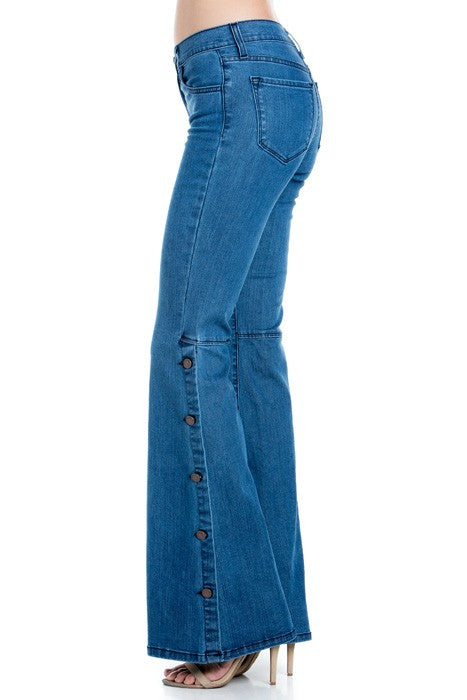 Medium wash denim jeans side view with long front button trim and gold topstitch