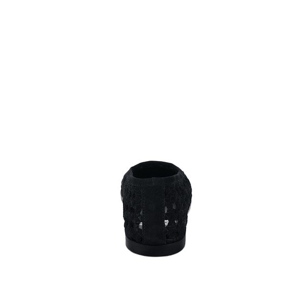 Black suede ballet flats, heel view showing perforated texture and low sole