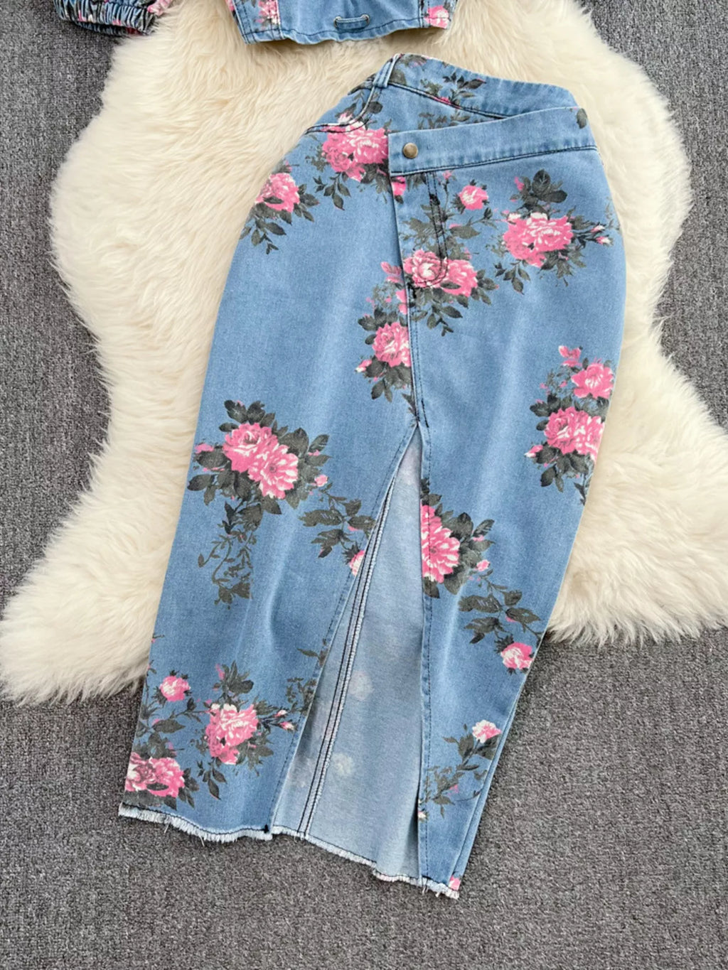 Blue denim skirt with pink floral print, front slit detail and button waistband