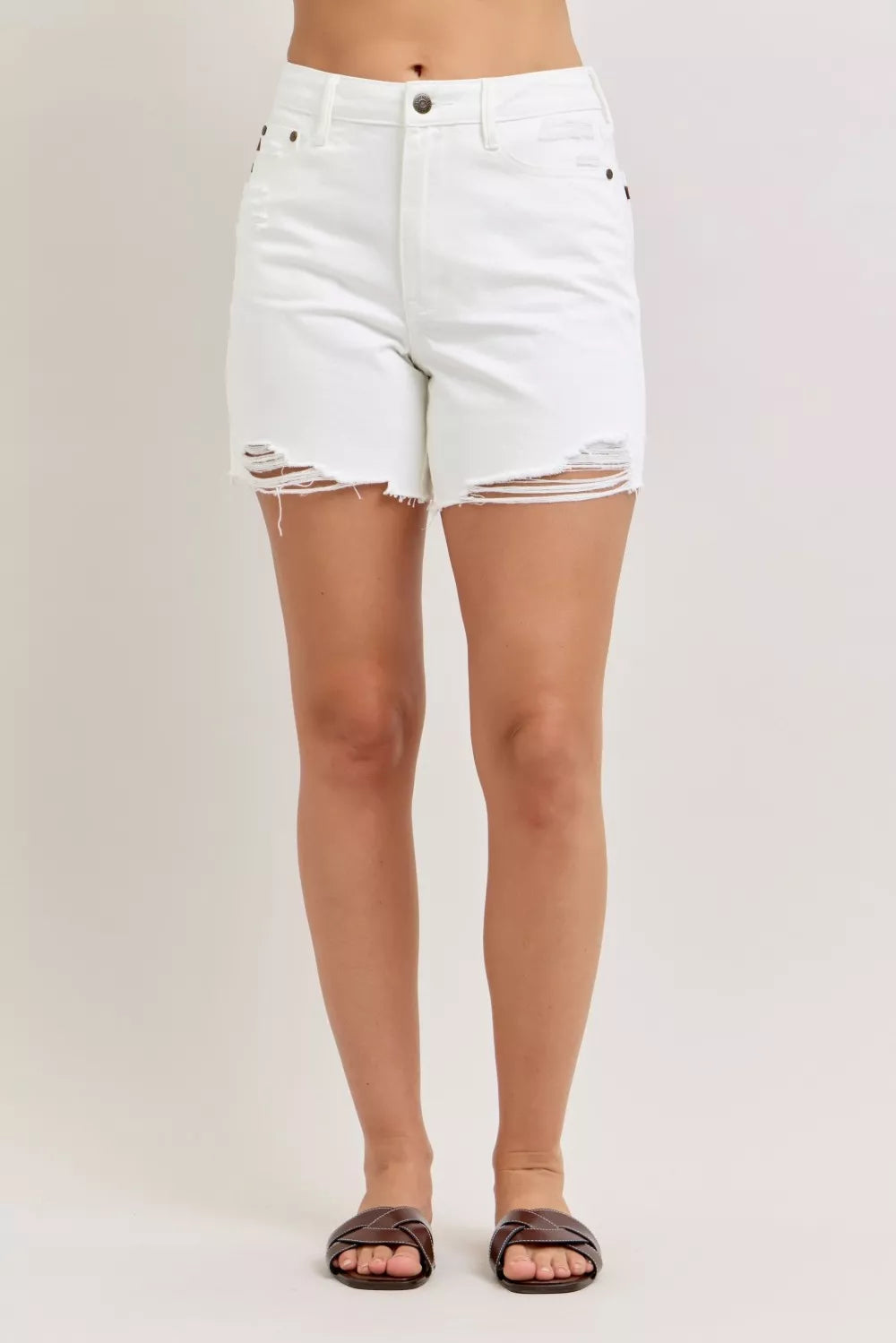 High-waist white denim dad shorts with ripped, frayed hem and button fly