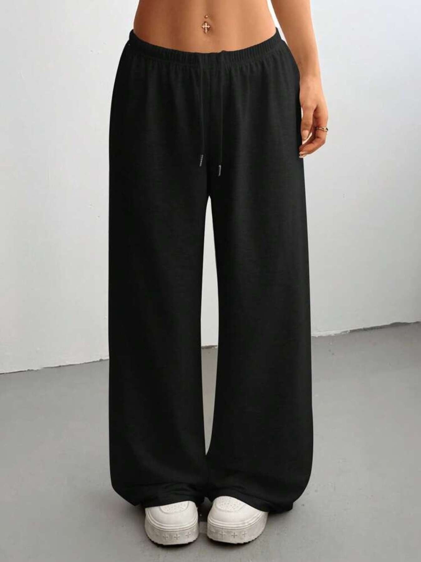 Black relaxed drawstring pants, loose wide-leg fit with gathered elastic waistband