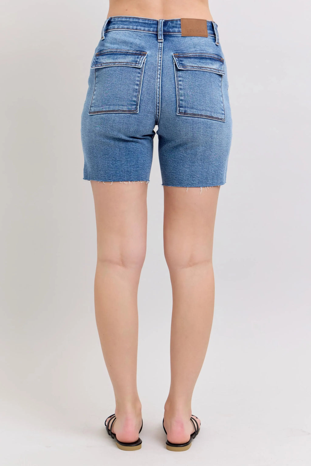 Plus-size mid-rise denim bermuda shorts, light blue wash, two back flap pockets, frayed hem