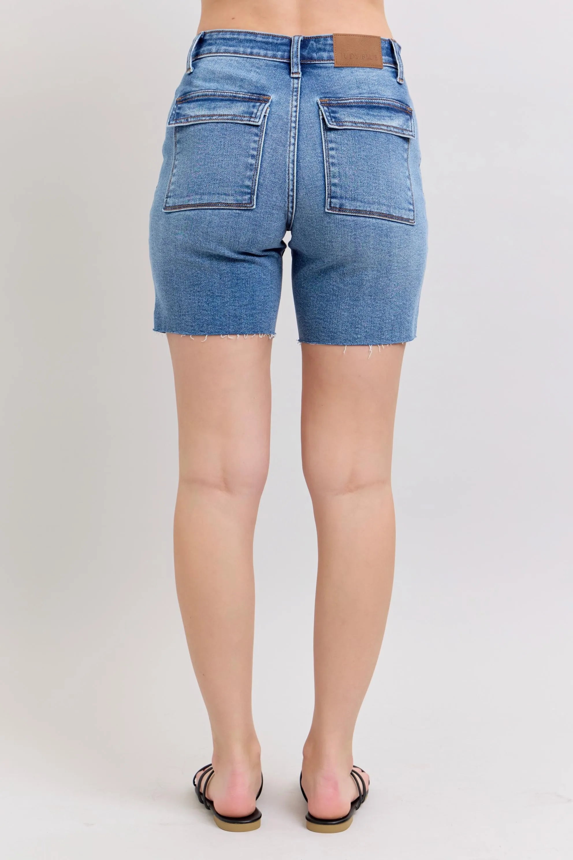 Plus-size mid-rise denim bermuda shorts, light blue wash, two back flap pockets, frayed hem