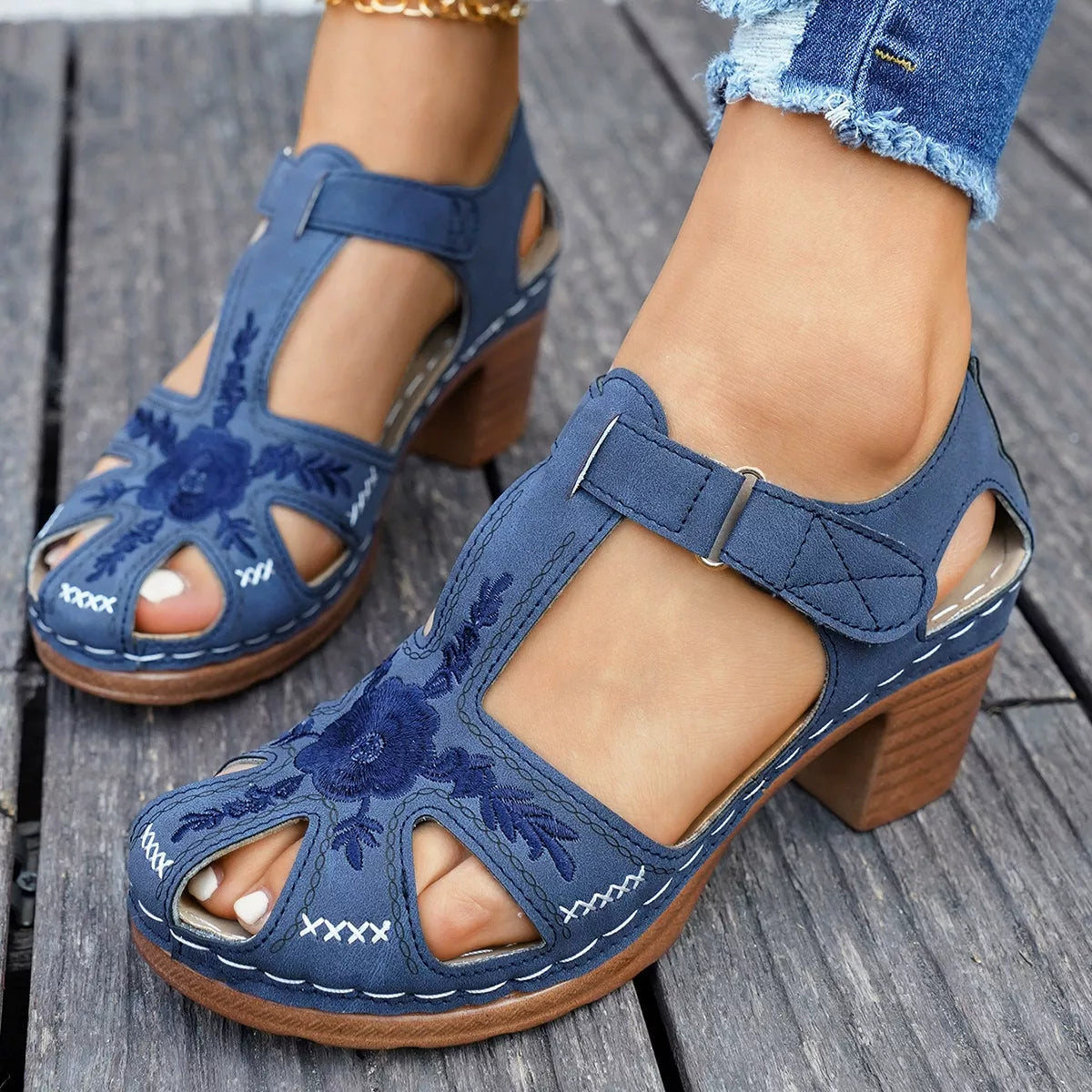 Blue cutout block heel sandals with double straps and floral cutout detail