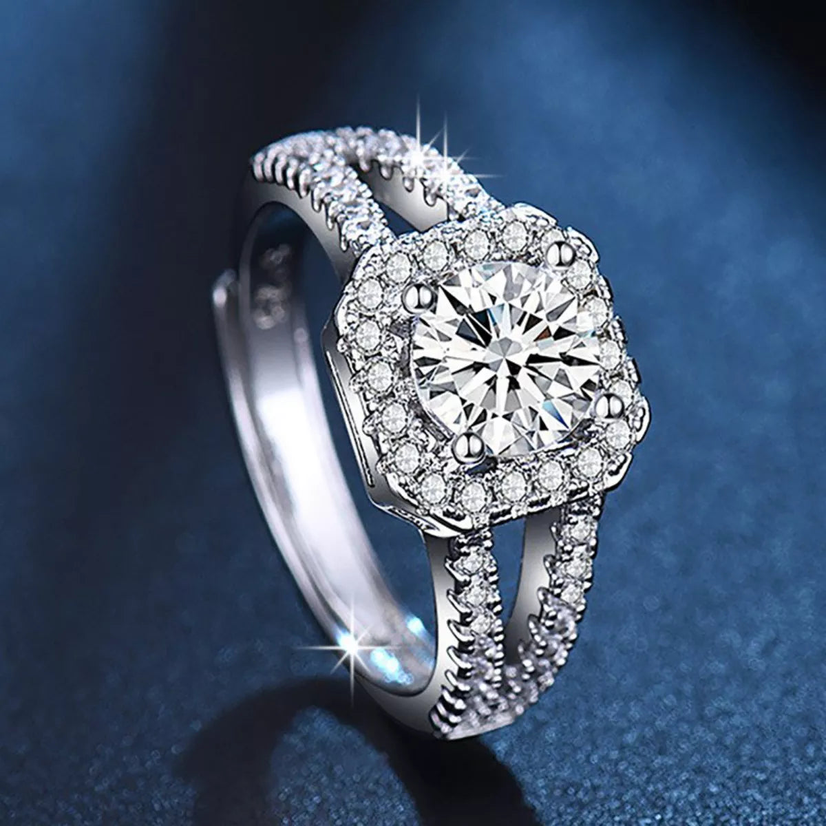 Sterling silver moissanite ring with large round center stone, halo pavé band