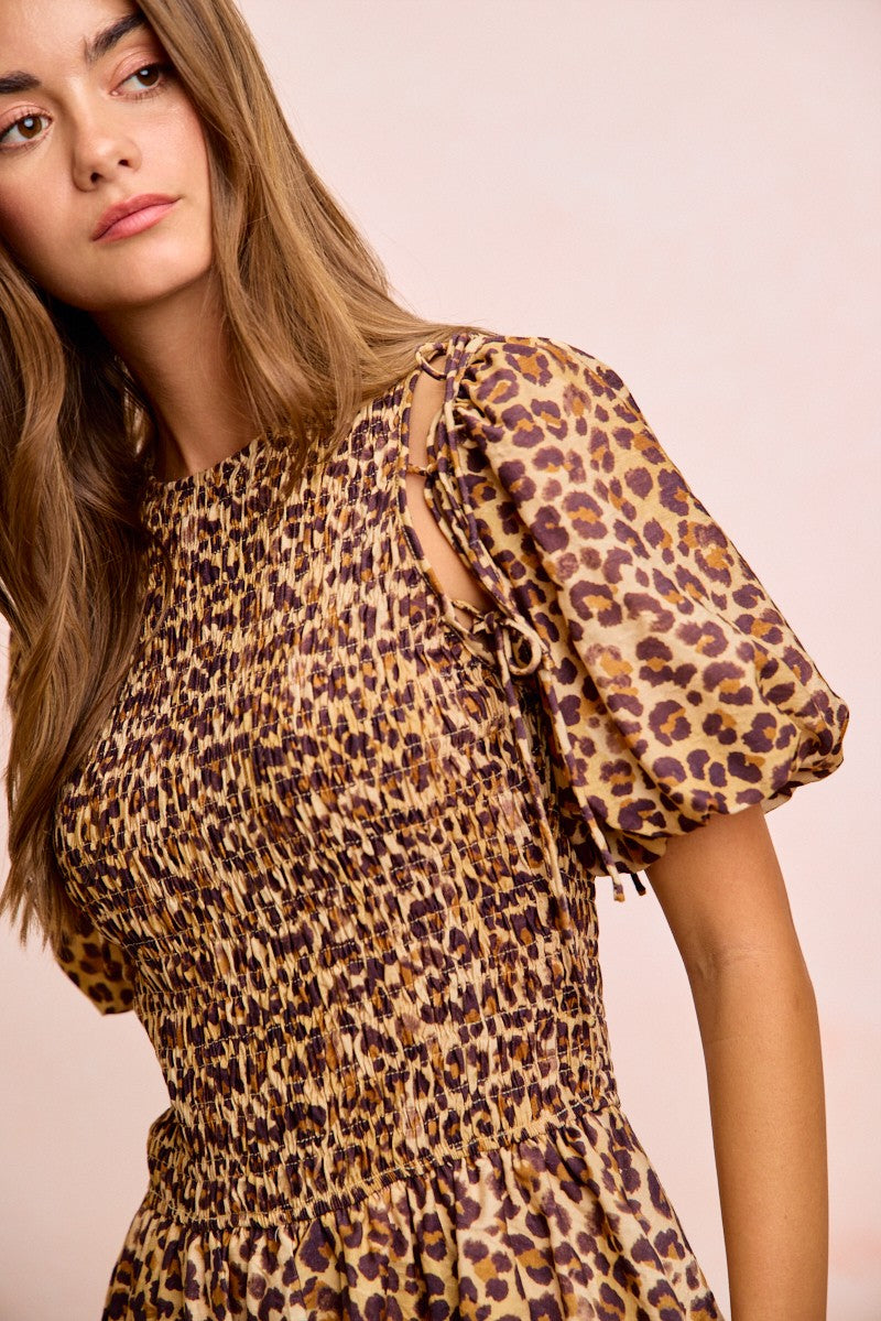 Leopard print puff sleeve with lace-up ties over smocked bodice